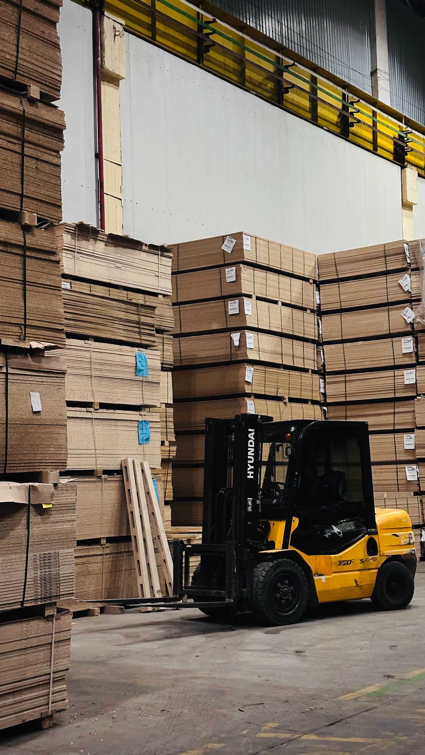 Forklift moving stacked freight in a warehouse, representing forklift operation as part of Summit's warehouse labour service